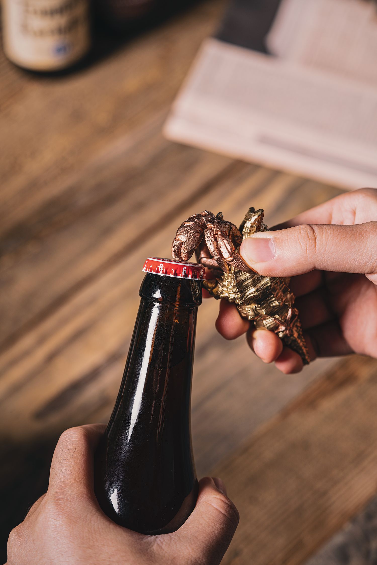 Bottle opener being used on a capped bottle
